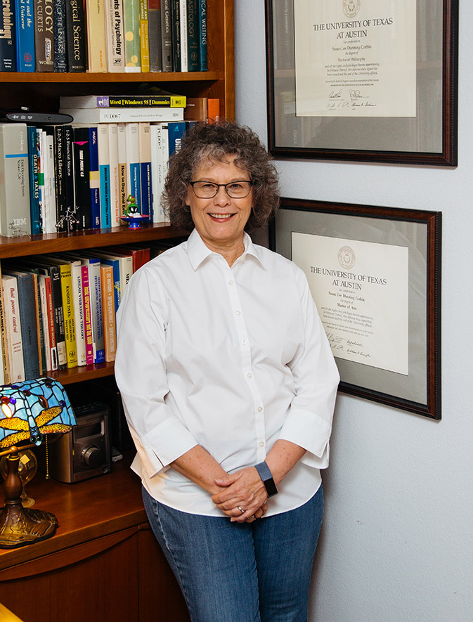 author and dissertation coach Susan D. Corbin standing in her office