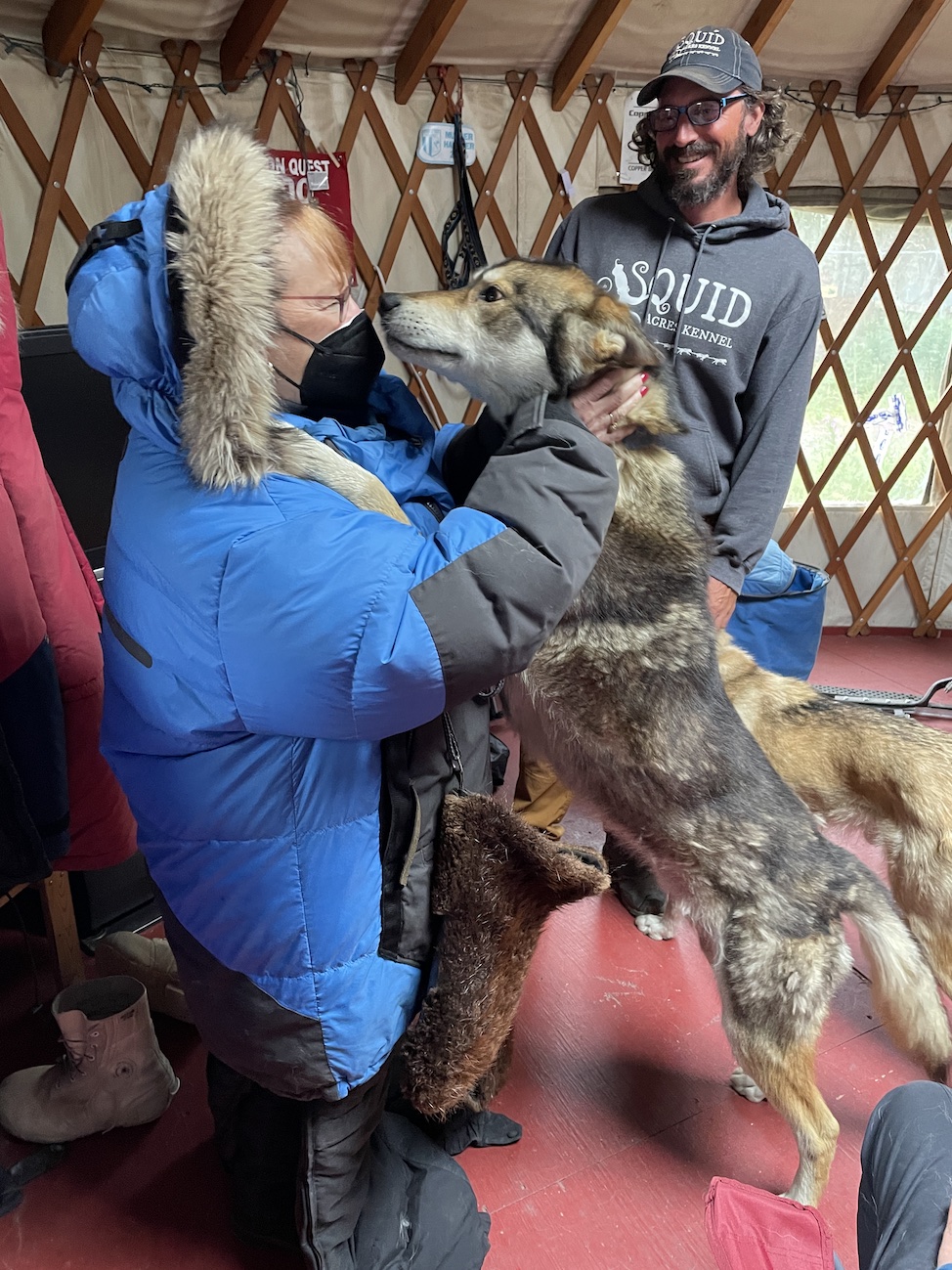 Cathy in sled dog outfit with dog