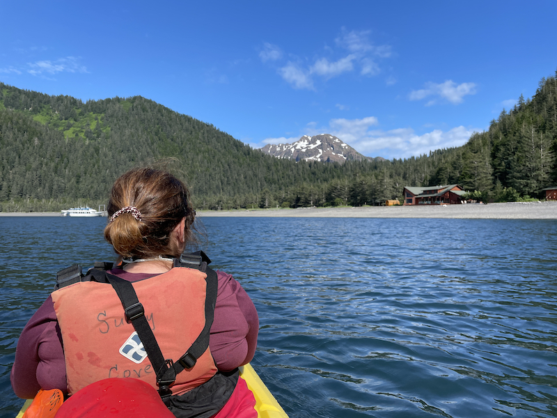 Krista going back to the lodge in a kayak