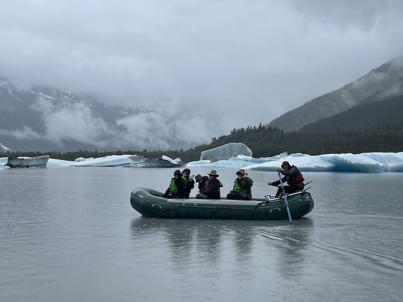 Rubber raft on Spencer Lake with Spencer iceberg in the background