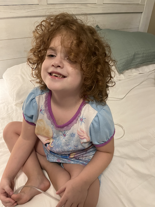 Curly haired Evie laughing