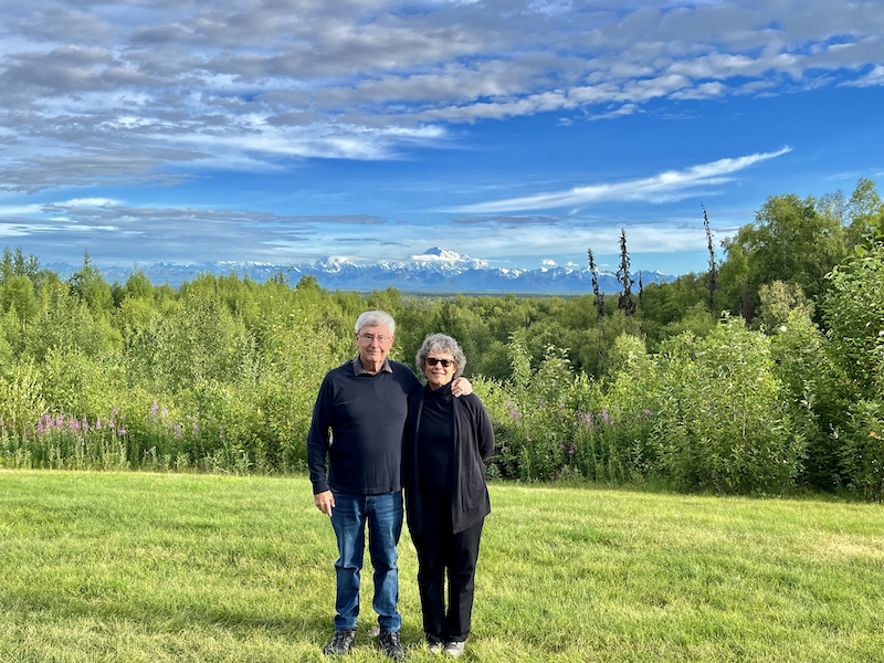 John and Susan on Talkeetna Alaskan Lodge lawn with Denali in background