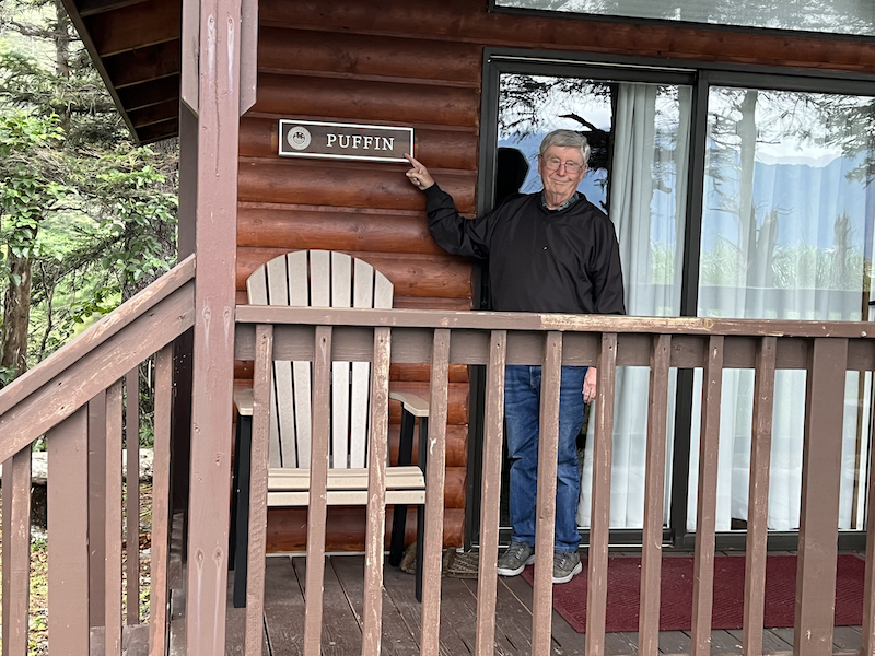 John in front of Puffin Cabin at the Wilderness Lodge on Fox Island Alaska 