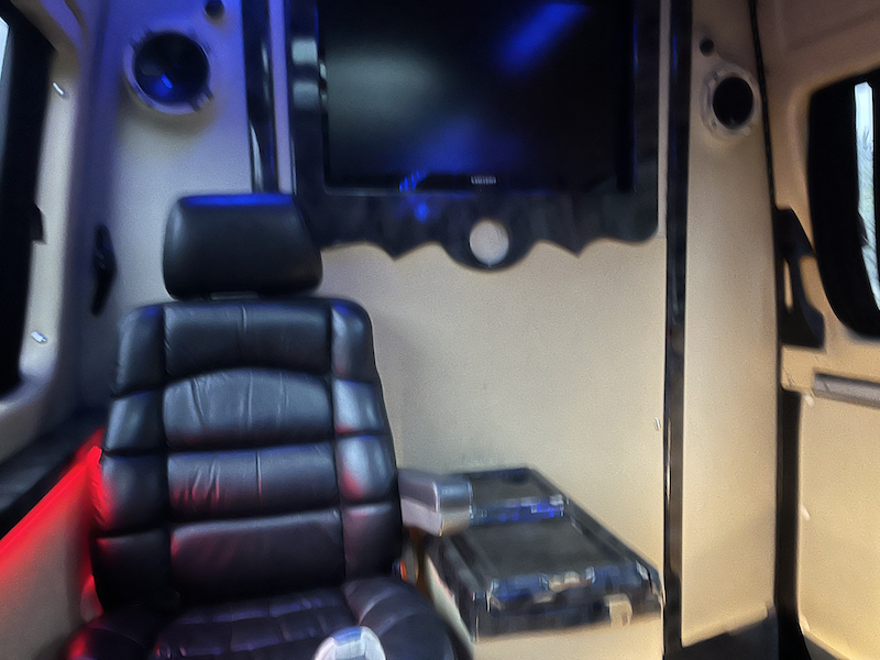 Inside the Istanbul party van with TV screen and black plush chair