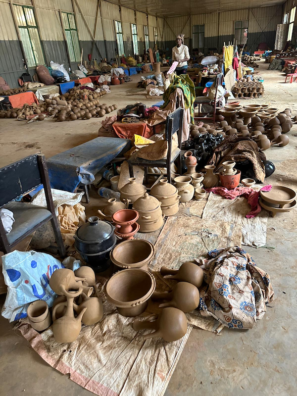 Inside building with clay pots drying on the floor