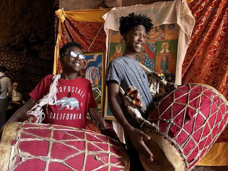 Boys with drums in stone church in Lalibela, Ethiopia