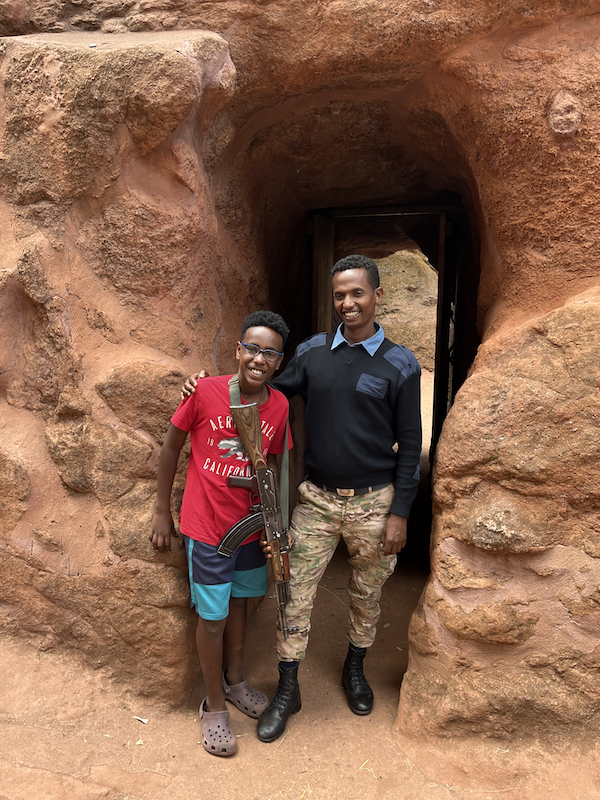 Sam with police officer at stone church, Lalibela, Ethiopia