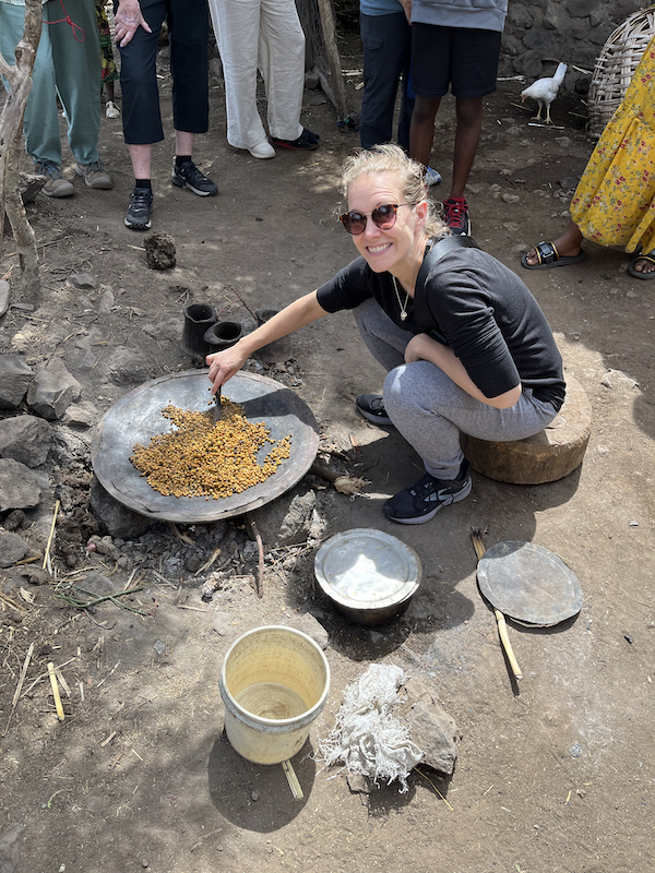 Becky stirring barley in Asheton Village, Ethiopia